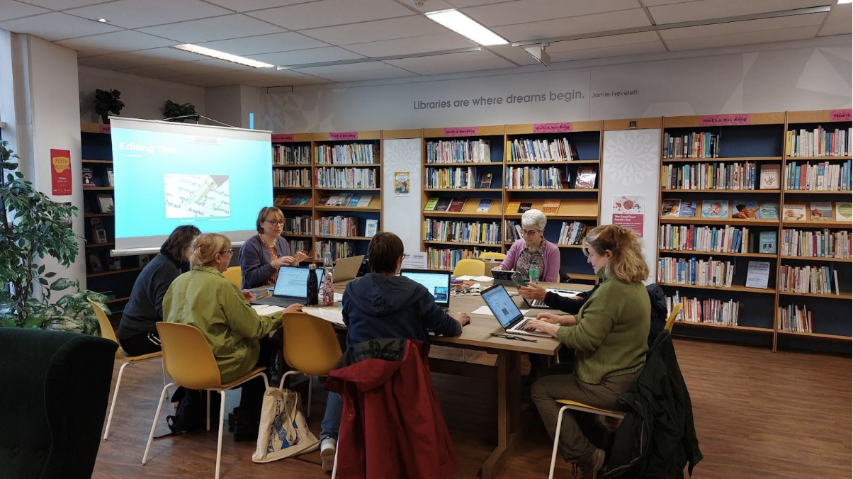 'Perth Women on Wikipedia’ Editing Group. Group of women sitting around a table with laptops editing Wikipedia