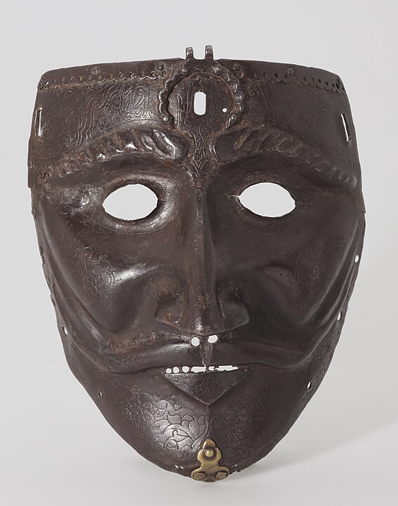 Photograph of an iron, steel and brass war mask.