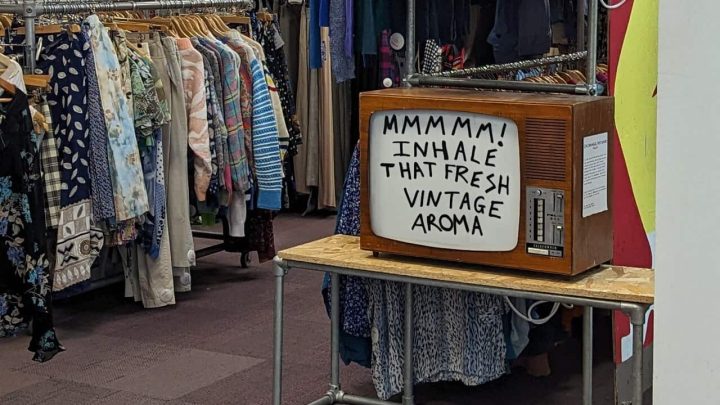 Photo of the Blue Rinse vintage shop in Leeds, with racks of clothes and an old TV.
