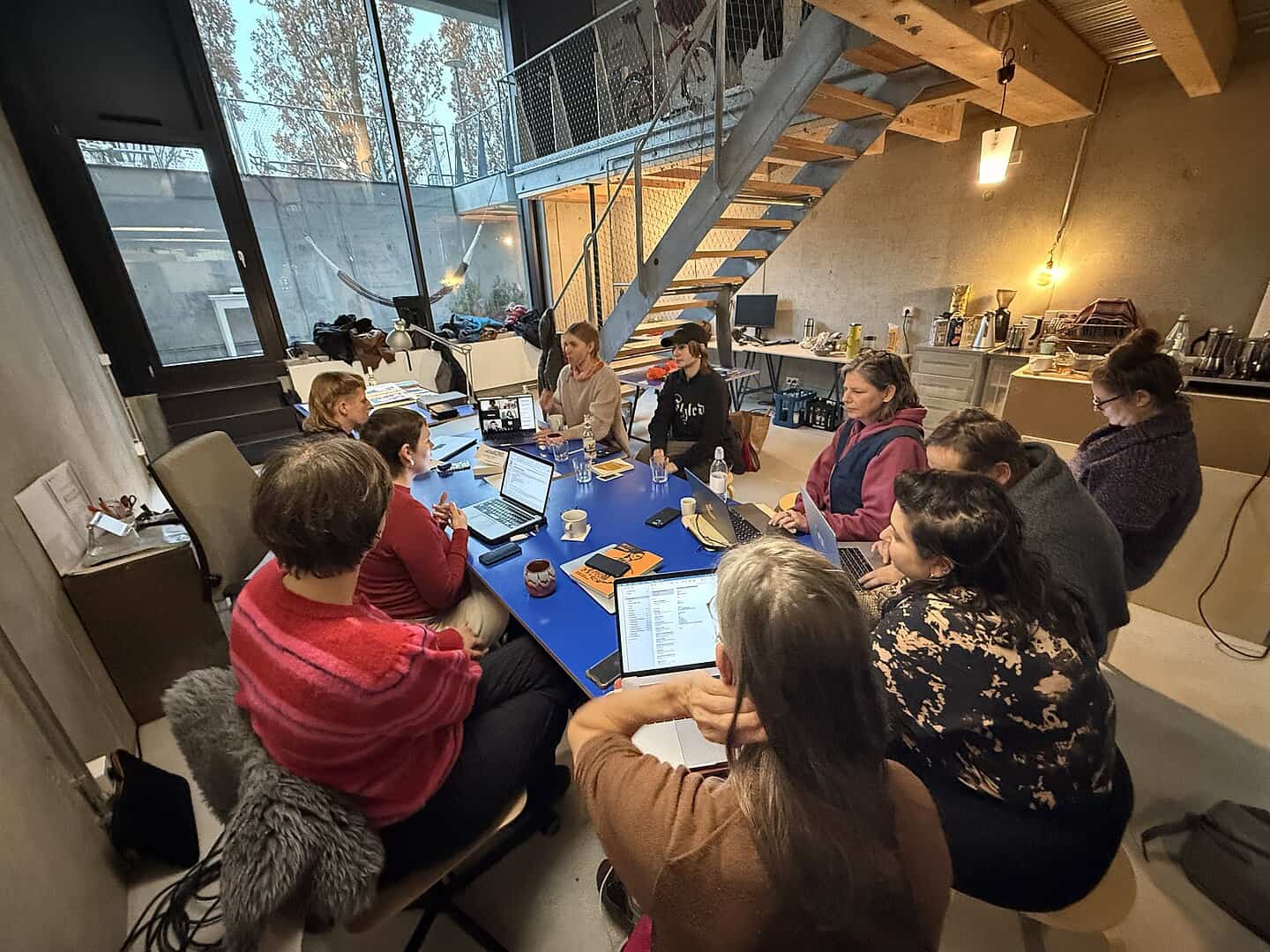 Photograph of the in-person editathon in Berlin showing a group of people sat around a table with laptops