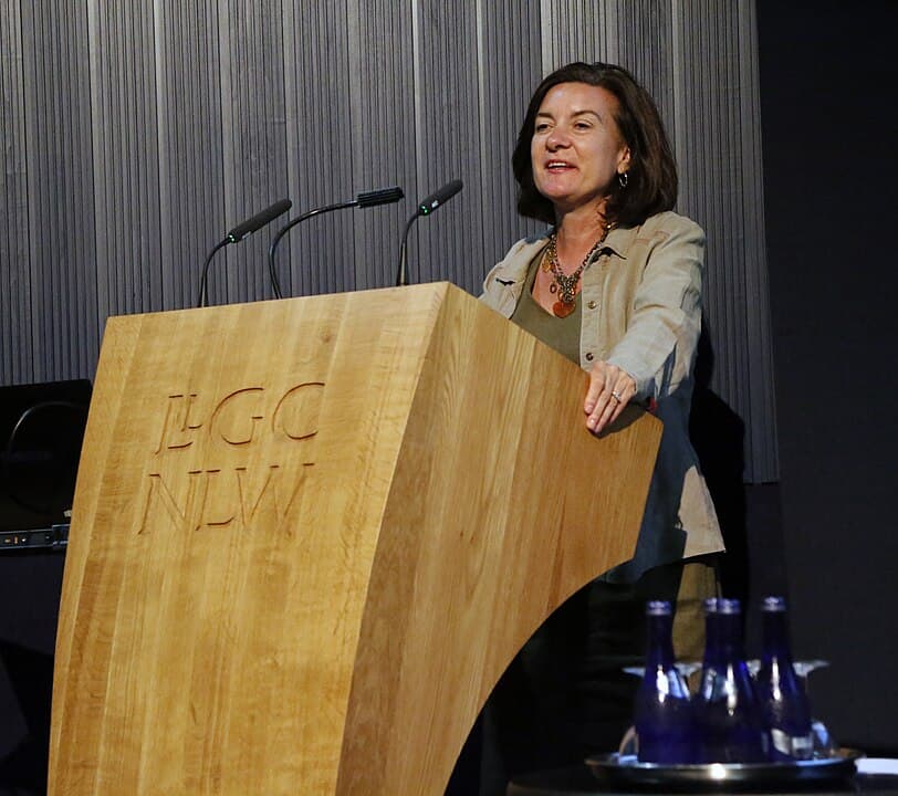 Photograph of Eluned Morgan, the then culture minister for Wales in 2018, behind a podium at the NLW opening the 2018 Celtic Knot.